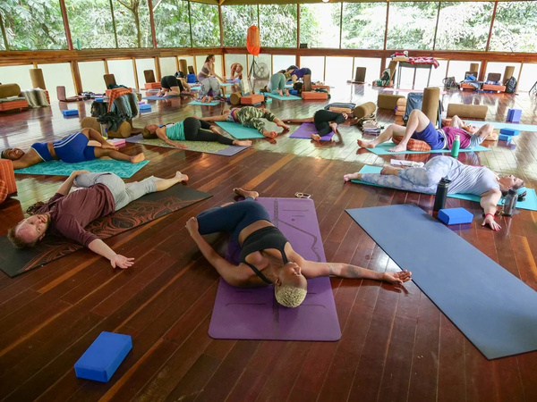 A yoga teacher training group practices together in our large event space
